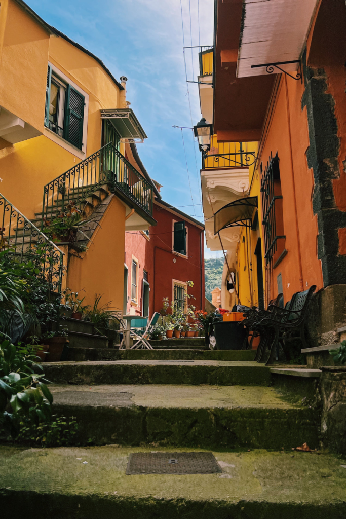 Image of Airbnb rental along a colorful city street with steps leading down the lane