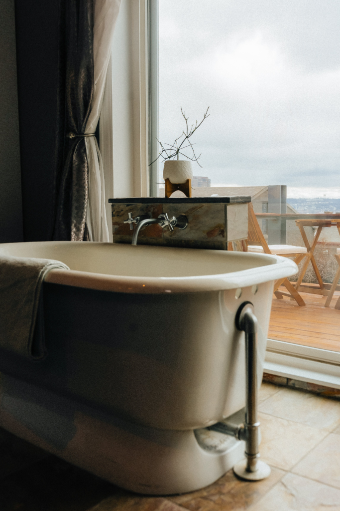 Image of Airbnb with free standing bathtub beside a window with a nice view