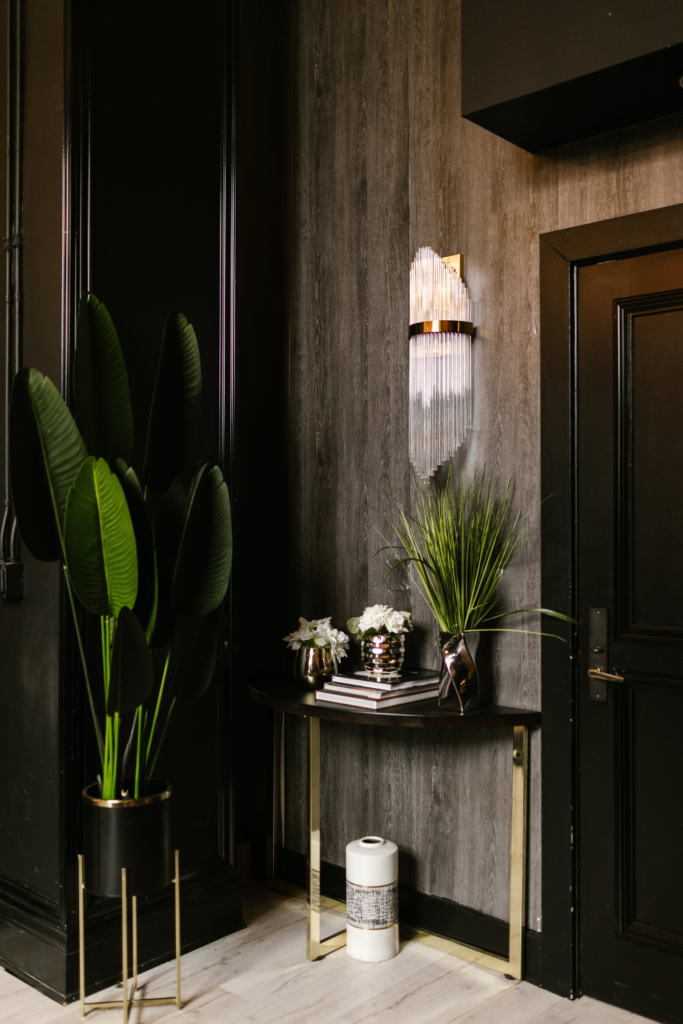 Image of Airbnb hallway with side table and greenery along wall