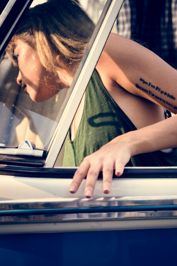 image of blonde woman getting into front seat of vehicle