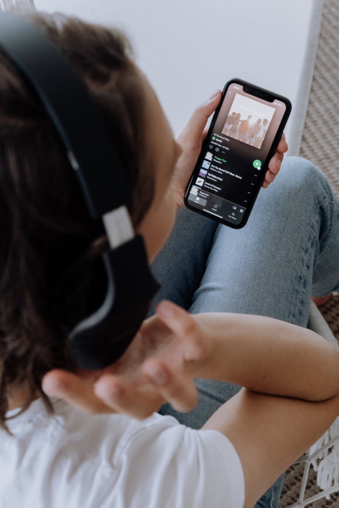 image of woman listening to spotify on cell phone