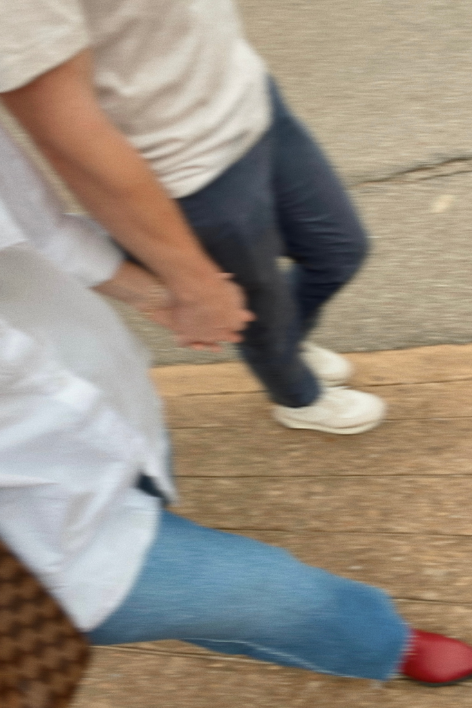 Image of couple holding hands and walking down the street side by side in Atlanta Georgia