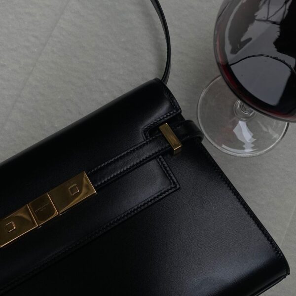 Image of black purse and glass of red wine on a white table during a date in atlanta