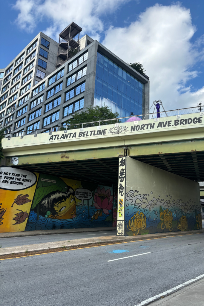 Image of the walkway over North Avenue NE in Old Fourth Ward Atlanta. The image shows a colorful mural painted underneath the overpass