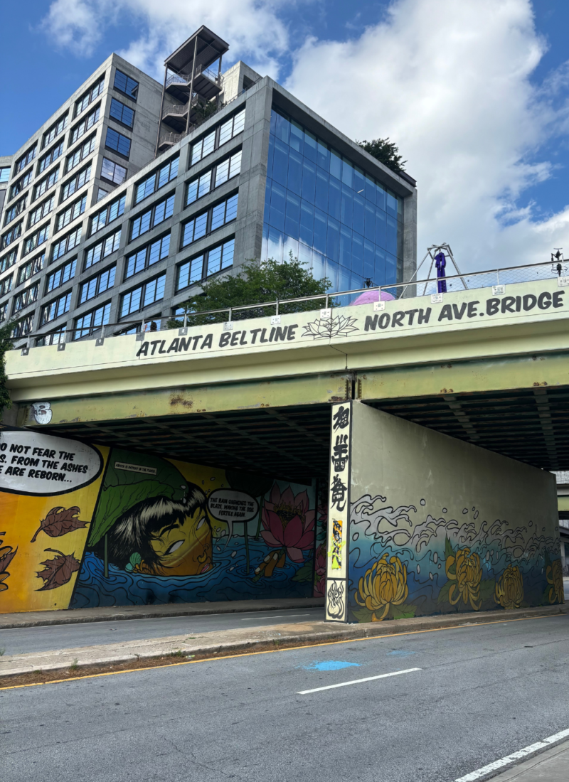 Image of the walkway over North Avenue NE in Old Fourth Ward Atlanta. The image shows a colorful mural painted underneath the overpass