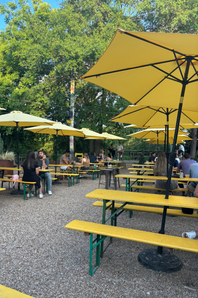 Image of bright yellow tables and outdoor umbrella shades at Ladybird Mess Hall in Atlanta Georgia