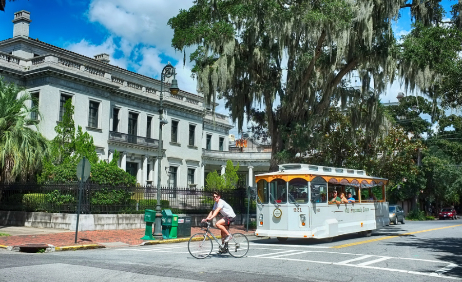 Image of Savannah GA street view with trolley and historic buildings.