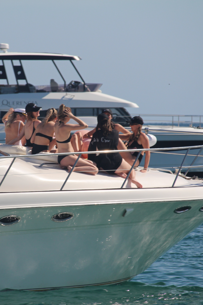 Image of women on the front of a yacht in Charleston Harbor, Charleston SC