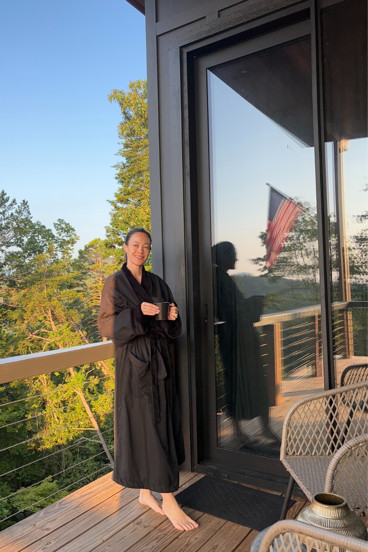 Image of woman standing on balcony in the sunrise at Yonah Suite at Viking Hilltop Rentals Helen GA