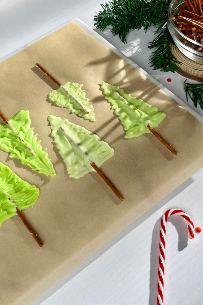 Image of Christmas tree shaped desserts on wax paper-covered cookie sheet.