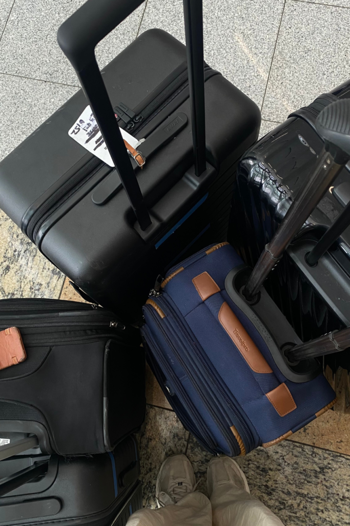 Top down image of dark colored carry on luggage that is one inch too big for size restrictions.