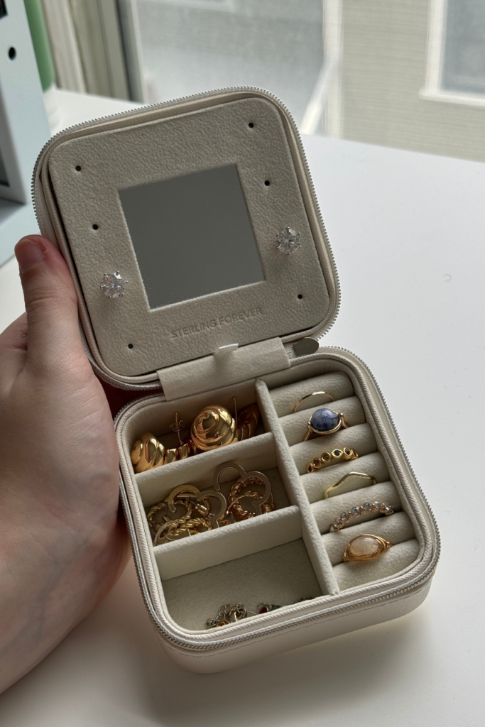 Hand holding tiny jewelry case for travel.