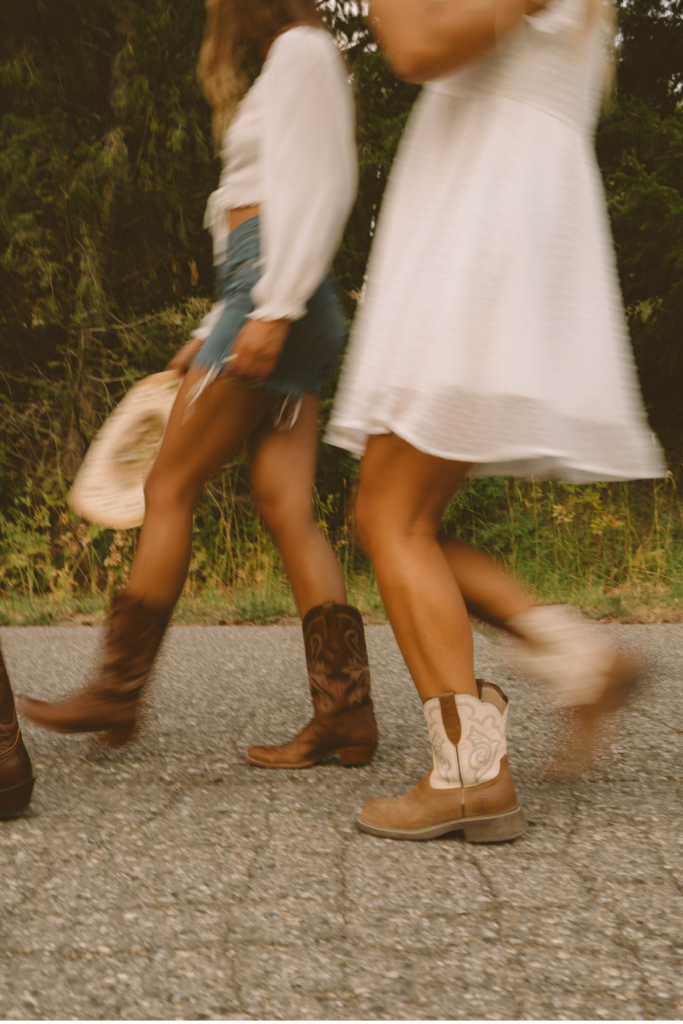 Two women with cowboy boots walking on the street in Houston Texas.