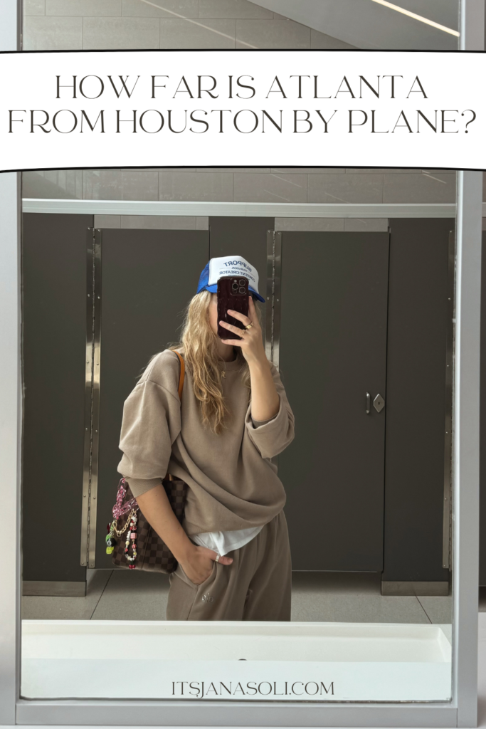 woman taking selfie in airport restroom with words on top of page that say How Far is Atlanta From Houston by Plane