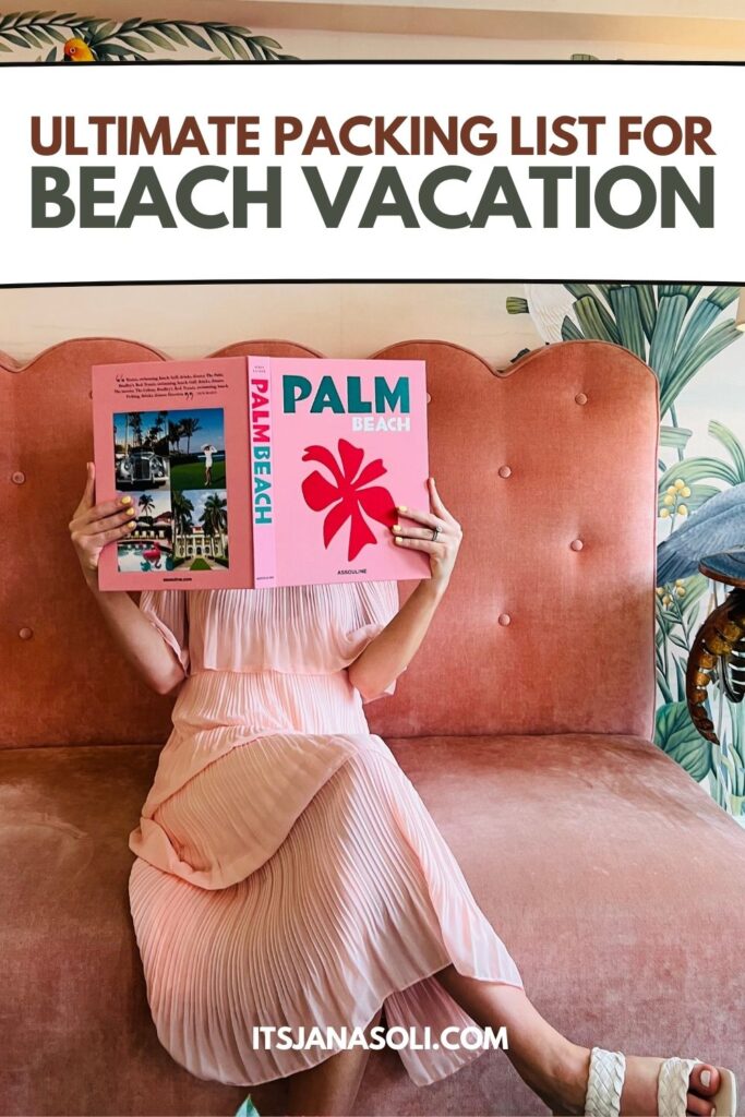 woman in pink dress holding magazine on pink sofa 