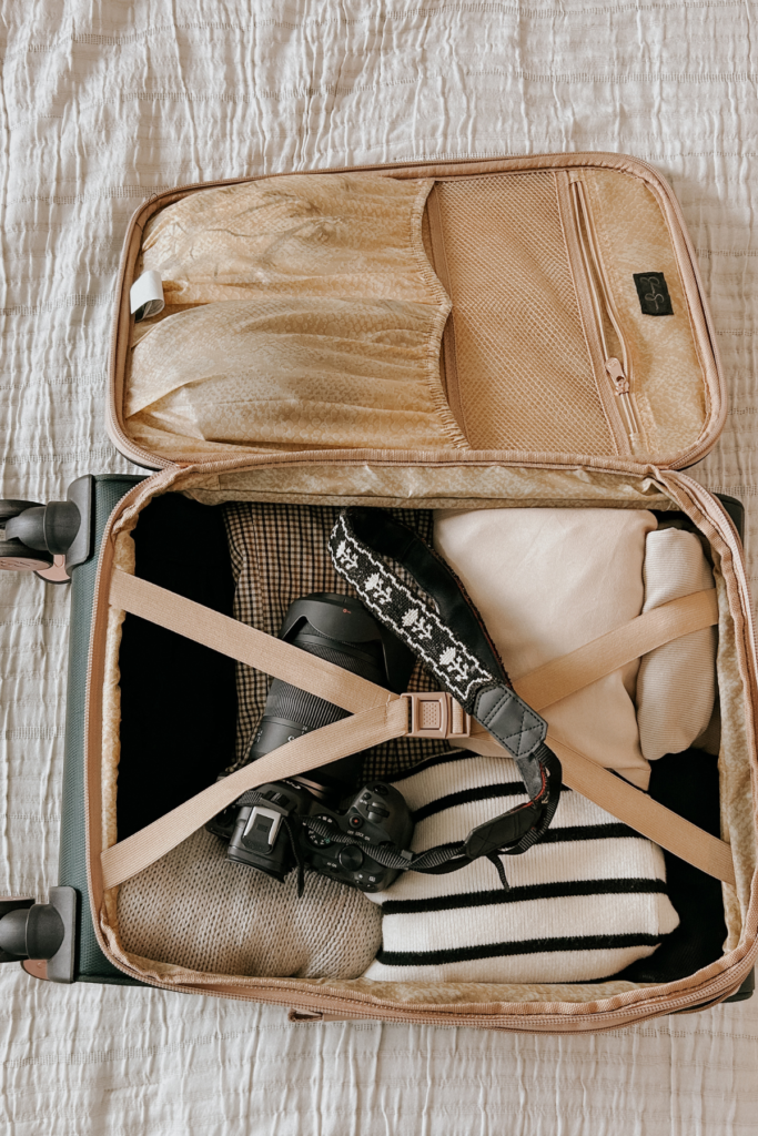 Pink suitcase opened with clothing inside